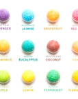 Assorted aromatherapy grace & stella bath bombs labeled with their fragrances and mood-inspired messages.