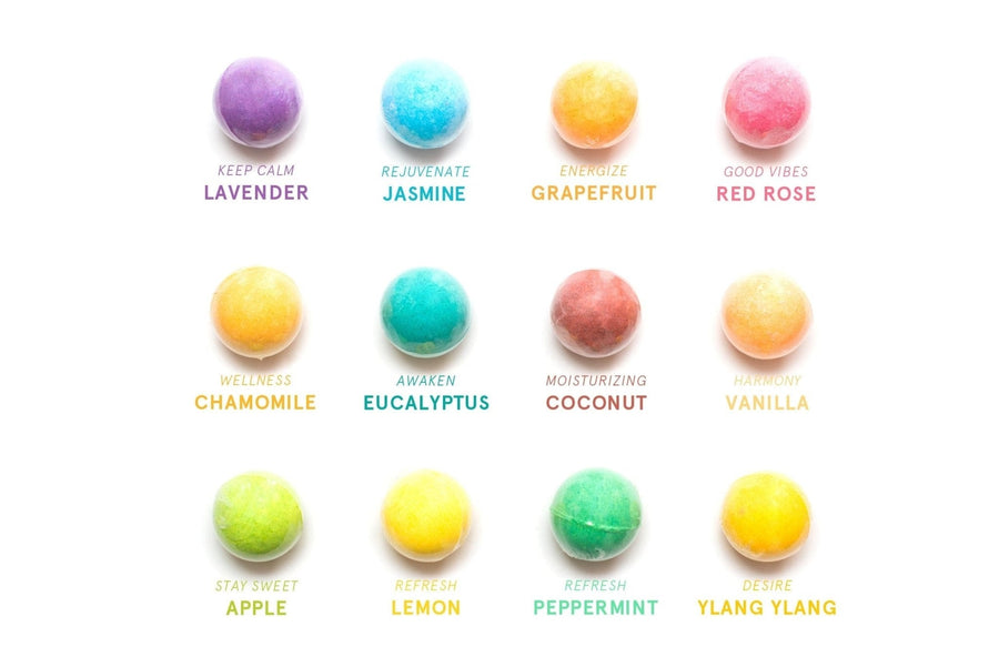Assorted aromatherapy grace & stella bath bombs labeled with their fragrances and mood-inspired messages.