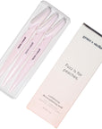Three pink grace & stella dermaplaning tools in packaging with the slogan "fuzz is for peaches.