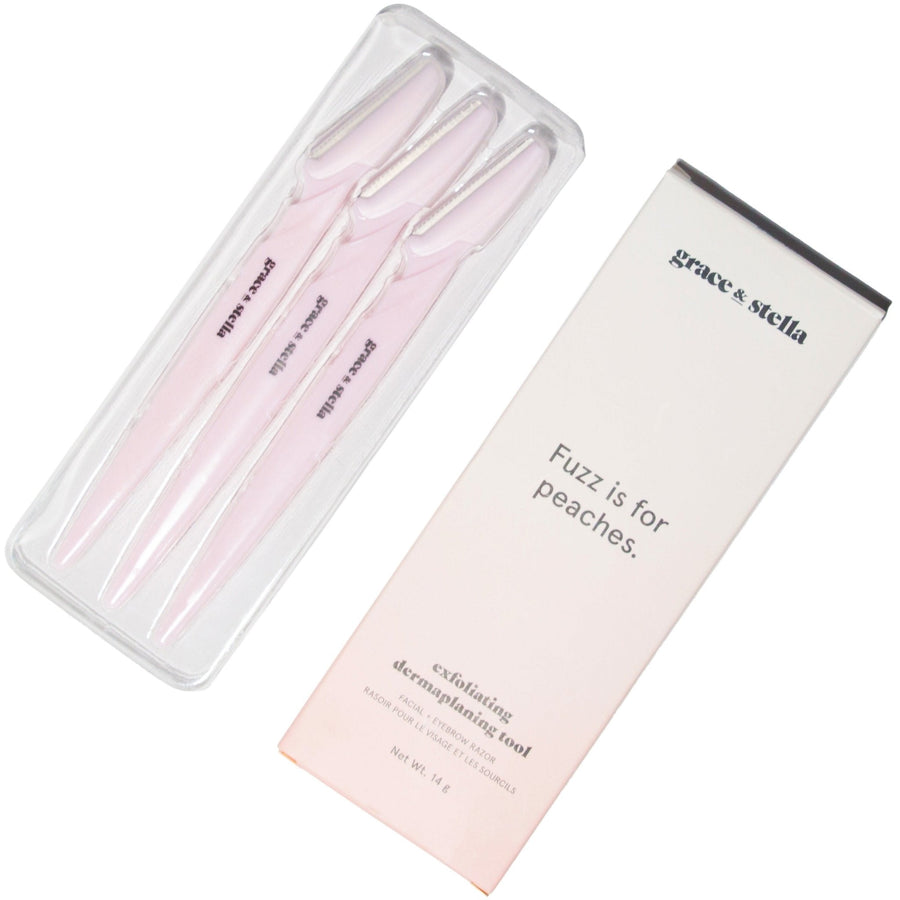 Three pink grace & stella dermaplaning tools in packaging with the slogan "fuzz is for peaches.