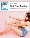 Woman applying dr. pedicure foot peeling mask, awarded "best of the foot product" in Marie Claire skin awards 2023.