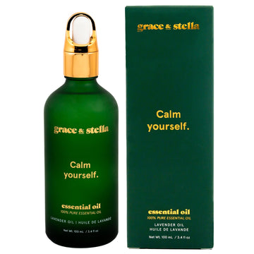 A green bottle of grace & stella Lavender Essential Oil, known for promoting relaxation and easing anxiety, with a gold cap next to its packaging box.