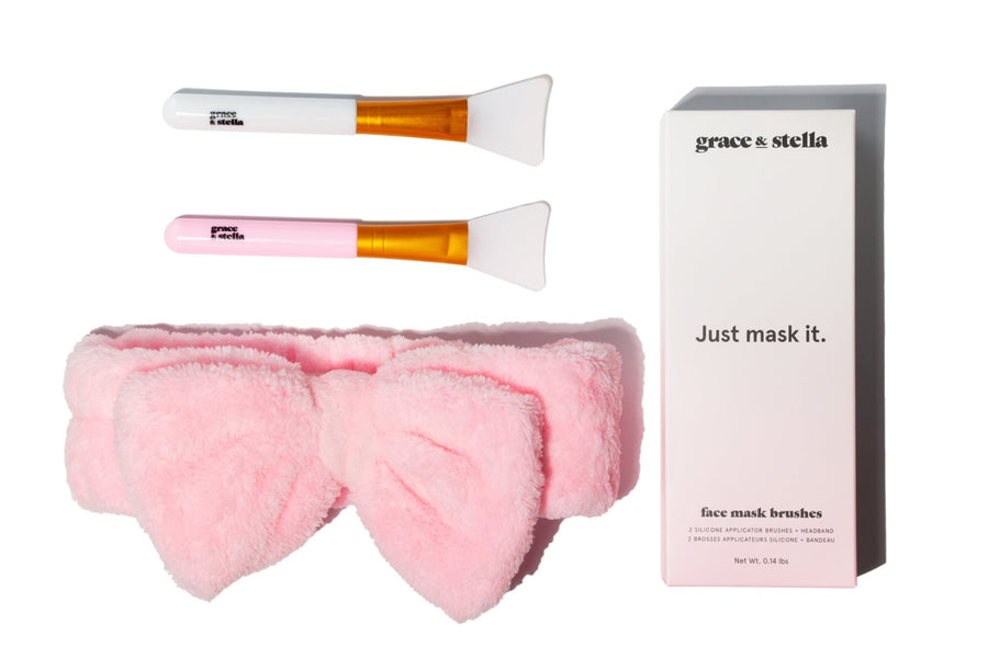 Facial mask application set with two Grace & Stella Co. silicone face mask brushes and a pink headband next to its packaging.