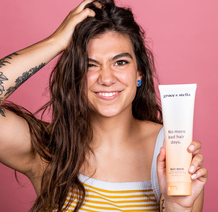 Woman smiling and holding a hair mask product, with text "grace & stella no bad hair days.