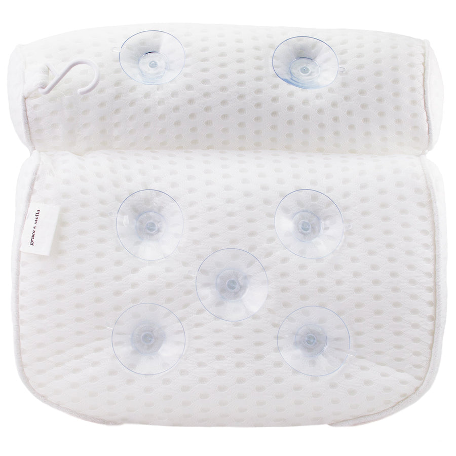 A white bath pillow by grace & stella with four buttons for relaxation.