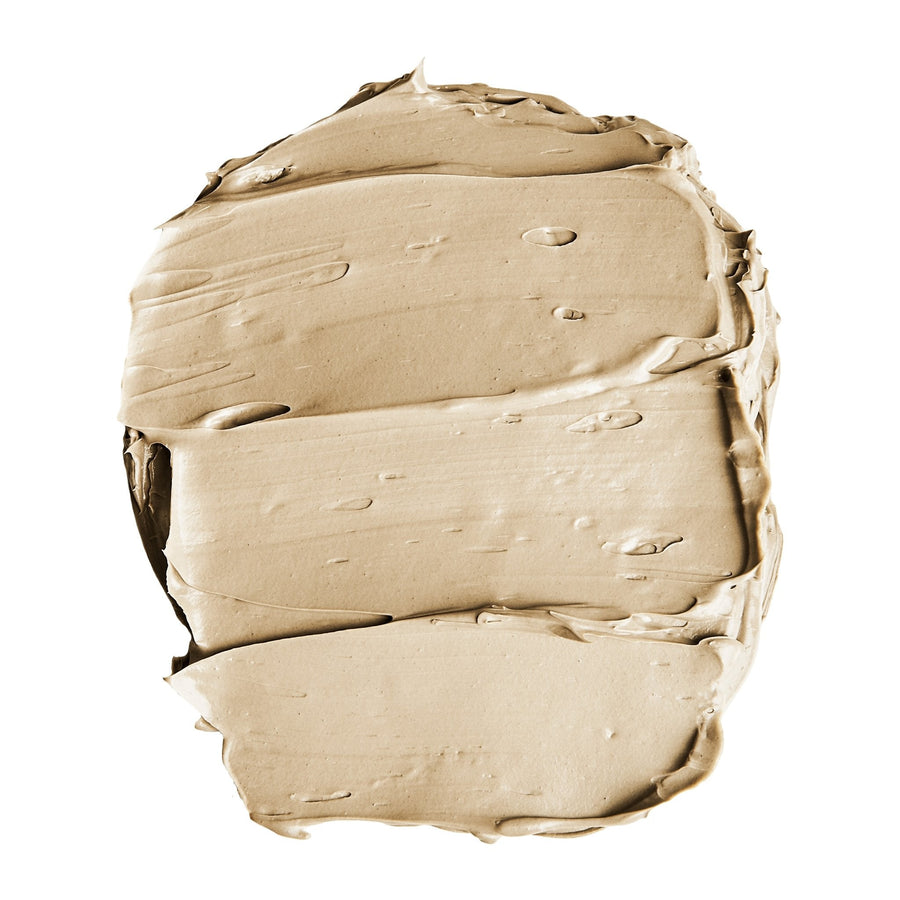 A close up of a beige colored cream, resembling a Grace & Stella Dead Sea Mud Mask, on a white background.