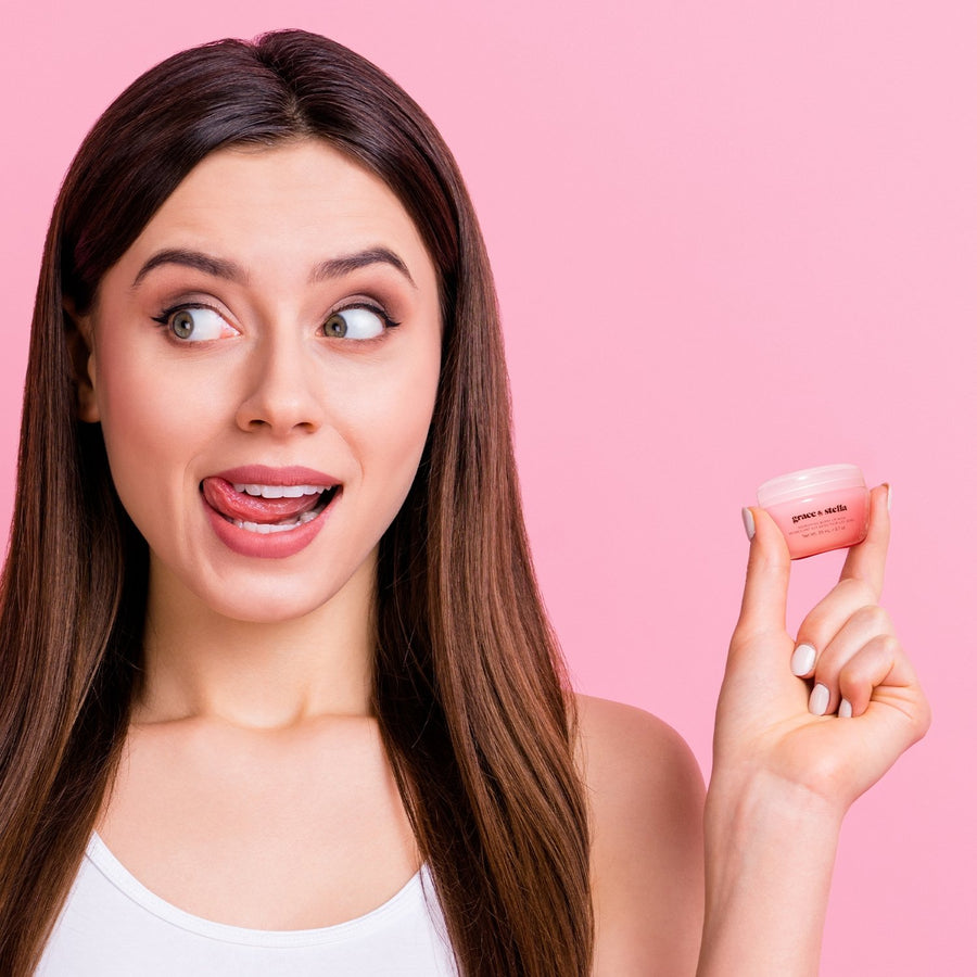 Woman holding a Grace & Stella La Vie En Rose Set with a surprised expression on a fresh pink background.